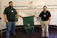 Student Matthew Foster and Professor Ben Levy presenting in Africa