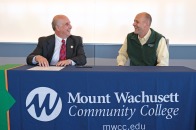 President Lapidus and MWCC President James Vander Hooven sign an articulation agreement on July 12 2022