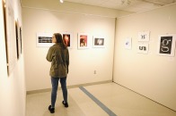 Female student in art gallery looking at exhibits