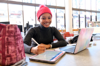 Student smiling in campus library