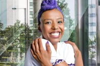 Embrace Equity female in purple giving herself a hug