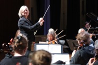 Hildy S conducting community orchestra in Weston