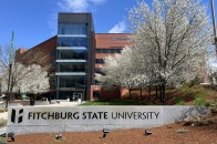 Front of Hammond Hall with sign and white flower trees