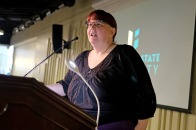 Professor Kisha Tracy at podium
