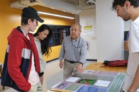 Professor talking with students in an Engineering Technology classroom