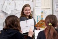 Student teaching at McKay reading to two female students
