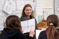 Student teaching at McKay reading to two female students