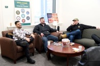 Male students sitting and laughing in the Veterans Center