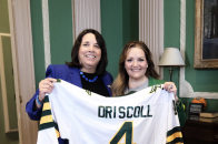 Lt. Gov. Driscoll poses with commemorative Falcons jersey presented by President Hodge