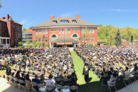Wide view of graduates posing in front of Edgerly Hall