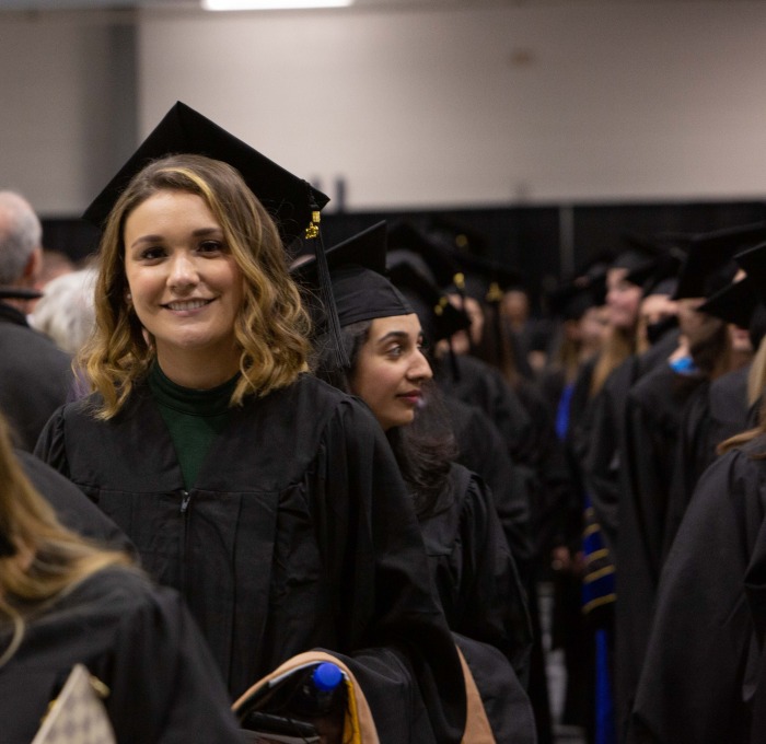 Smiling graduate student at commencement 