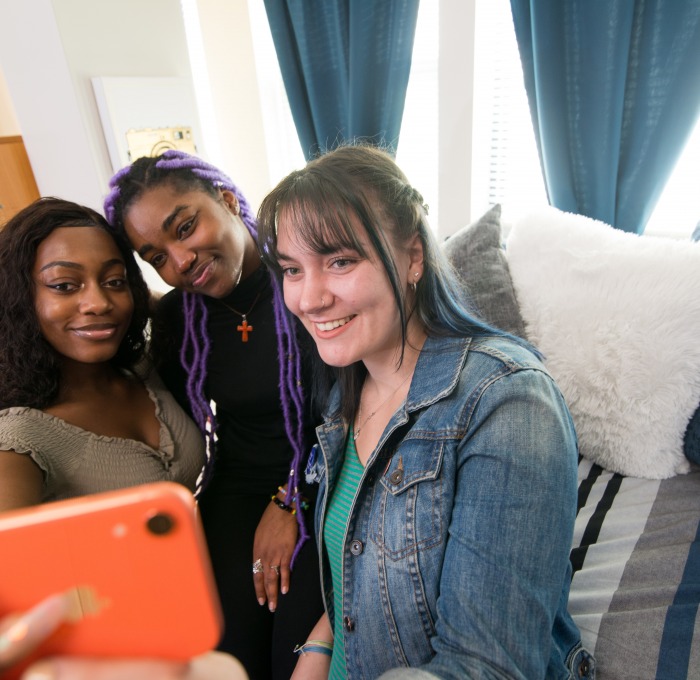 Fitchburg State students smiling as they take a selfie