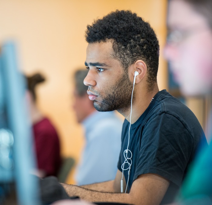 A student sitting at a computer 