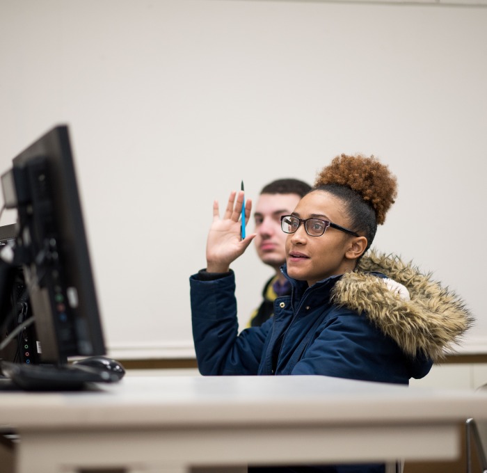 student with computer in class