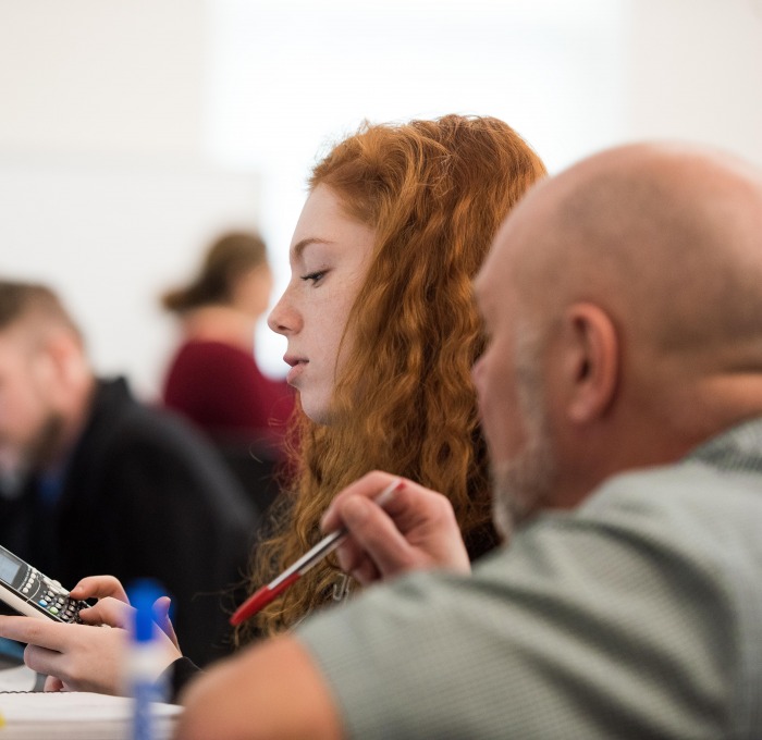 student being helped at the computer