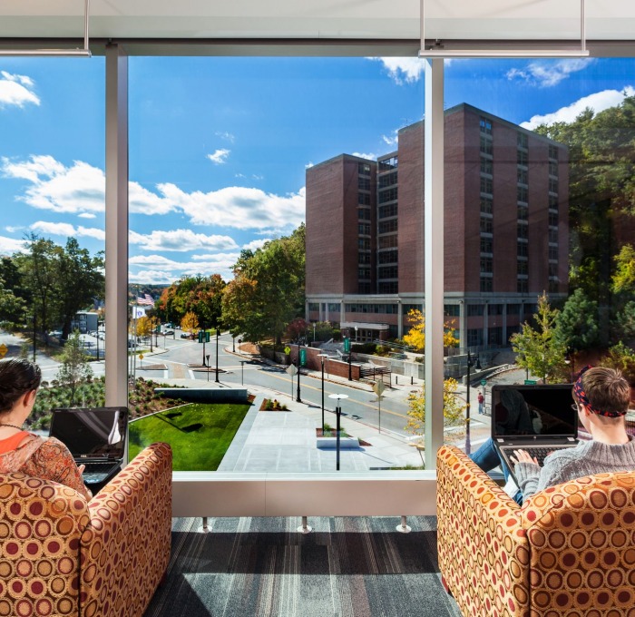 Students on campus using laptops 