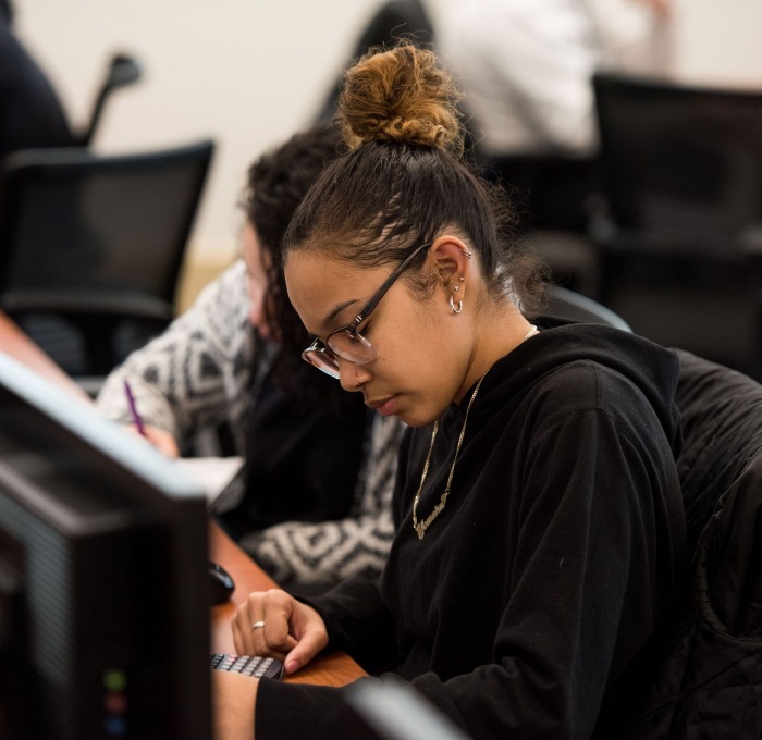 a student using a calculator in a mathematics classroom