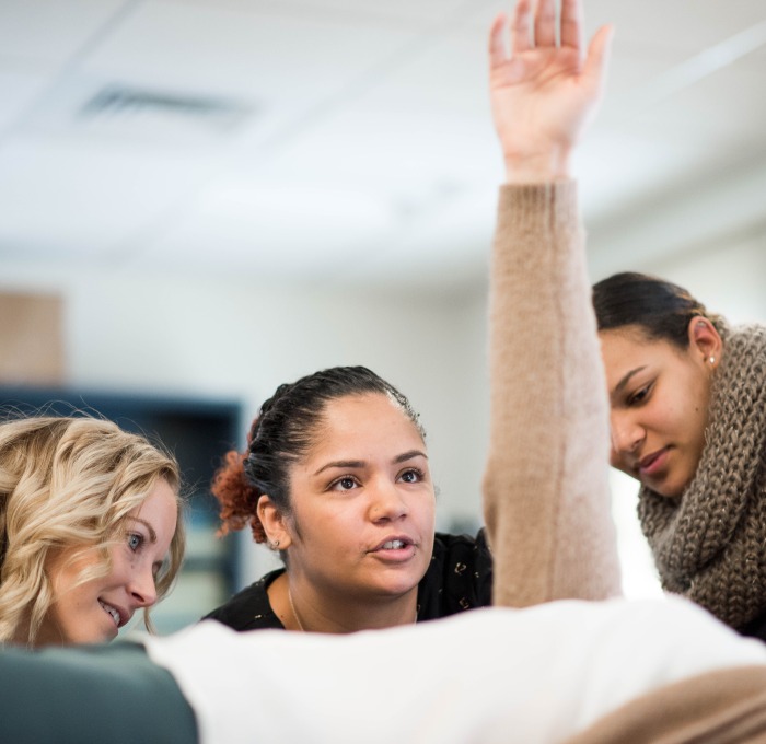 students examining another student