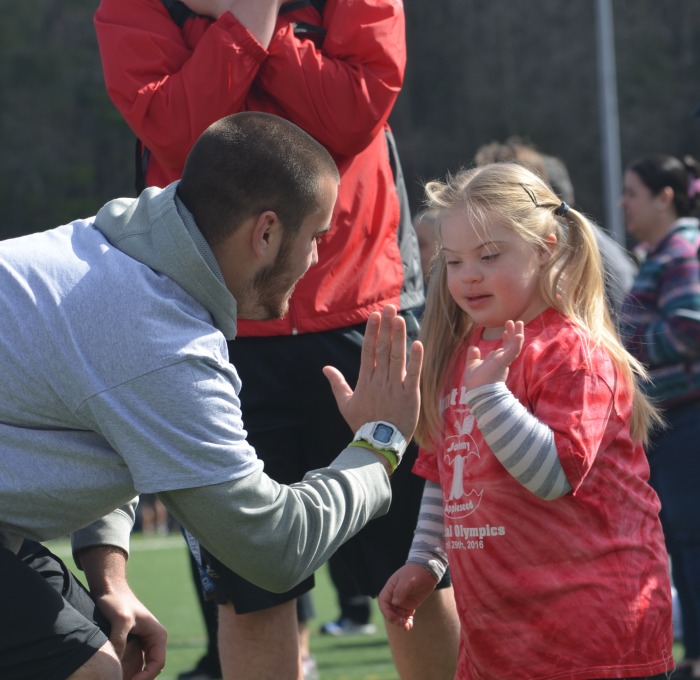 student and child at special olympics