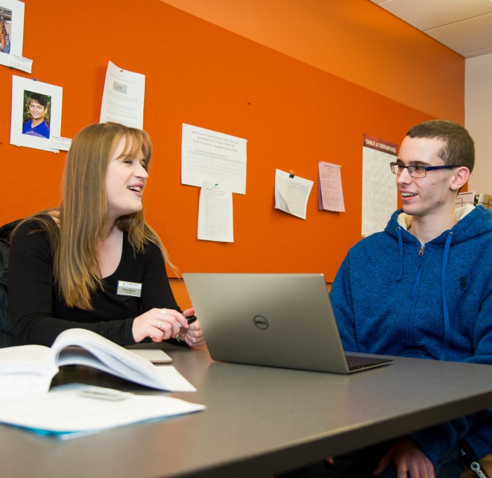 Counselor and student at table in counseling center