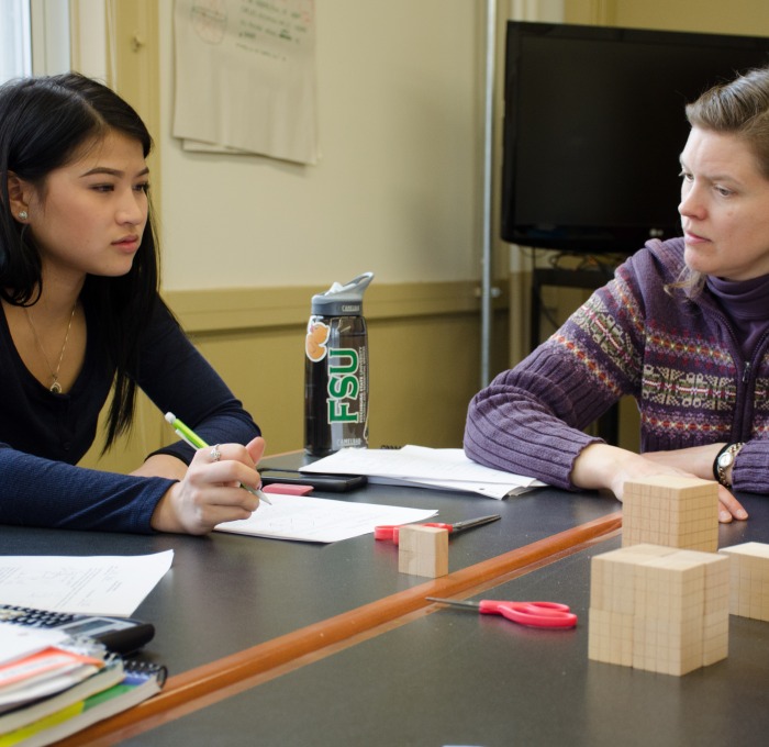 Teacher with student discussing math assignment