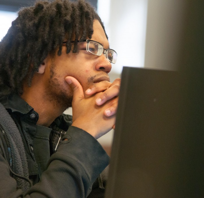 Student behind a computer screen in the classroom
