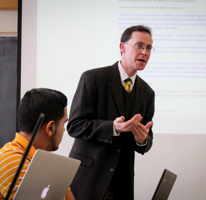 Professor Josh Spero teaching in the front of his class