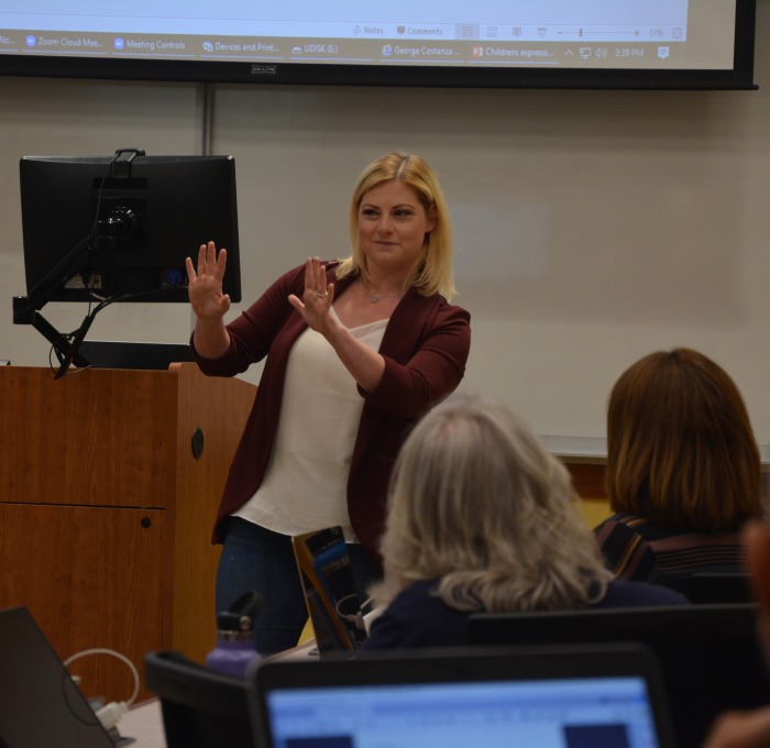 Faculty presenting in front of computer large screen 