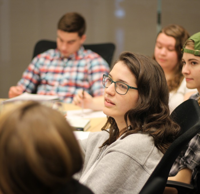Students in English Honors Classroom discussing book