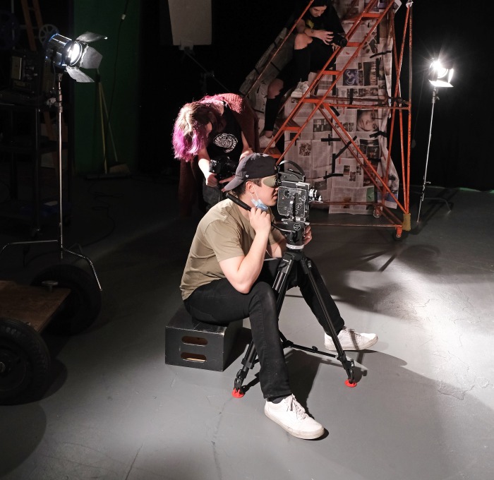 3 Film students working in the studio filming from different levels and angles
