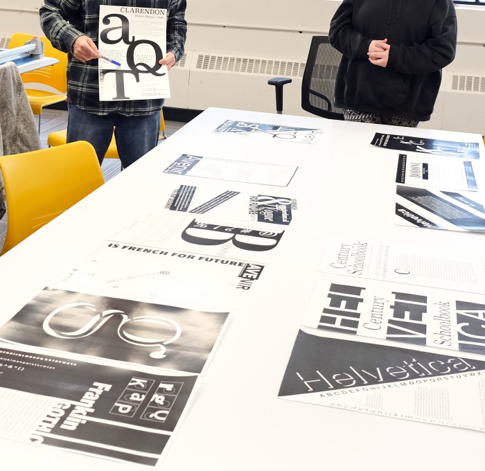 Professor Donald Tarallo reviews his student's work in their Typography Class