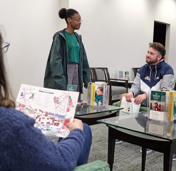 Welcome center interior with tour guide and potential students and families