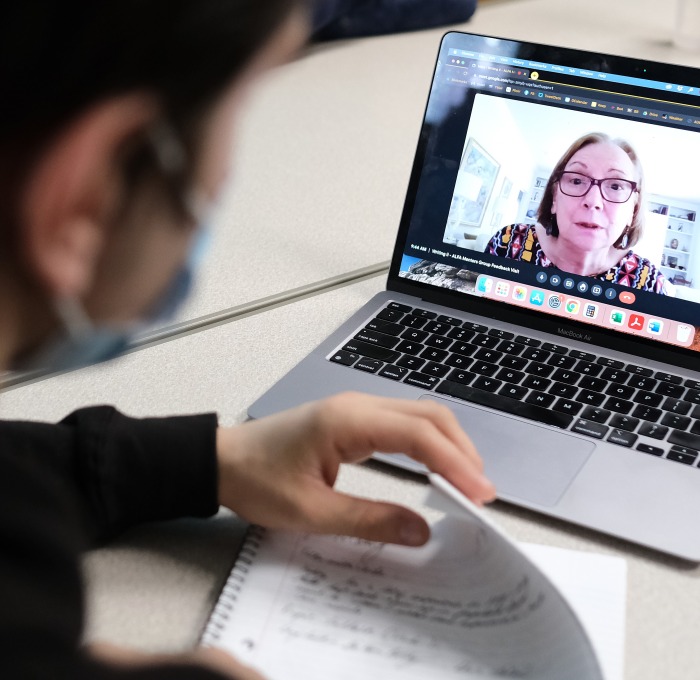 ALFA student mentor on laptop screen with undergraduate writing student