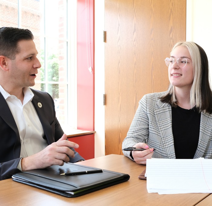 Rebecca Hess '22 and Michael Kushmerek State Rep at table in conference room