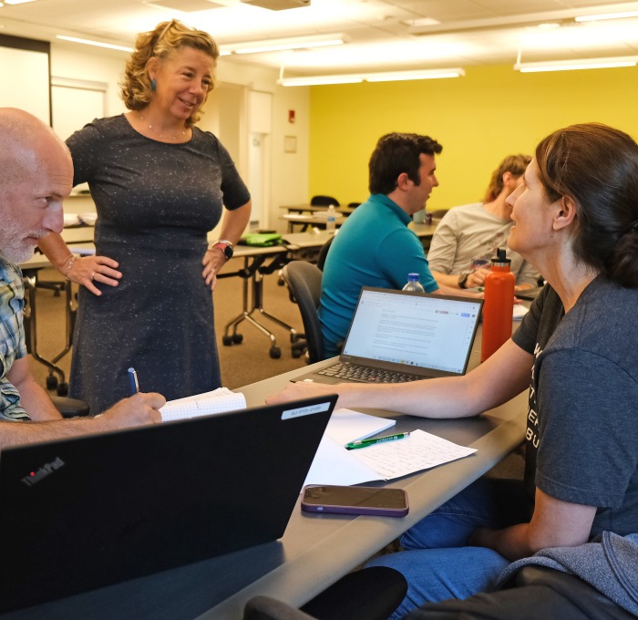 Teacher talking to adult students in AP classroom