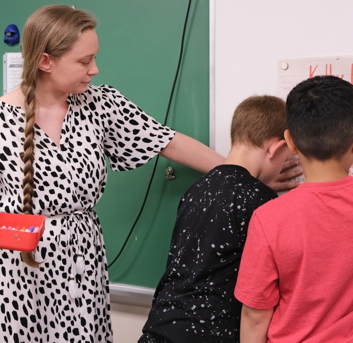 Teacher with students at the board in the classroom