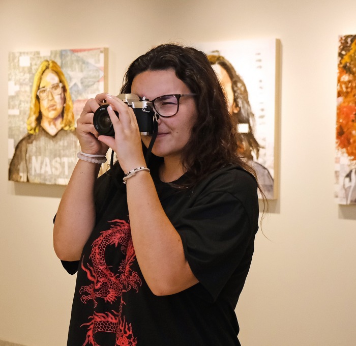 Girl taking photo in the art gallery