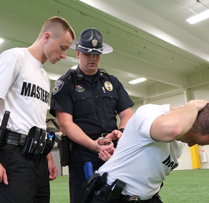 Police Academy students and officer working on handcuffing