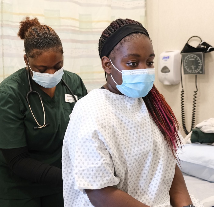 Nursing students one nurse on patient in respiratory lab