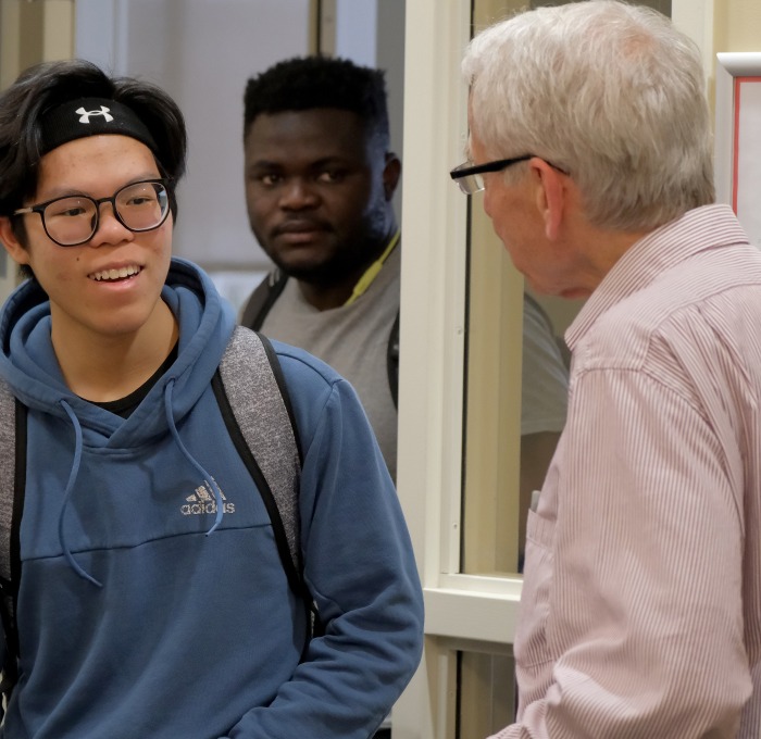 Math Honor Society Meeting professor talking to two male students