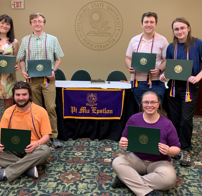 Math Honor Society (PME) Inductees 2023 posing with their awards in President's Hall