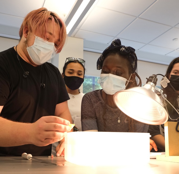 Upward Bound math and science students in lab working on experiment