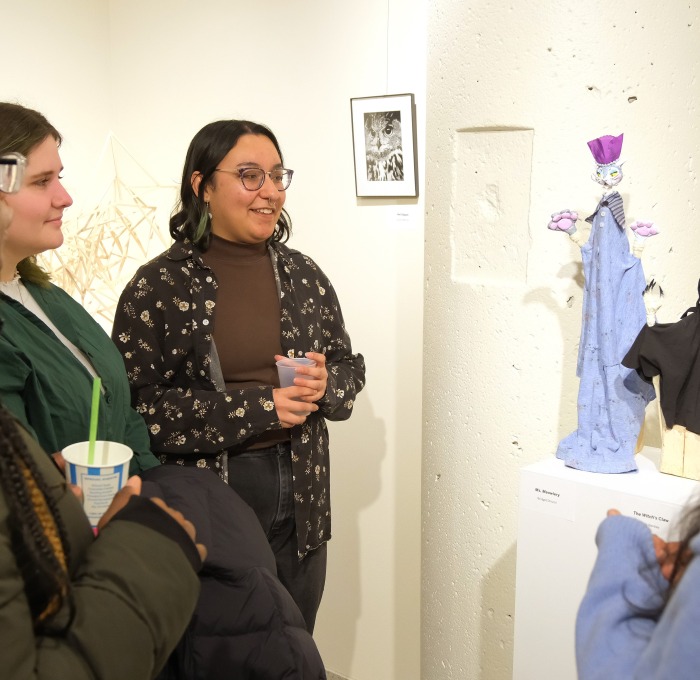 Female students in art gallery admiring sculptures during Arteries