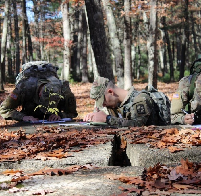 ROTC recruits on ground in the woods