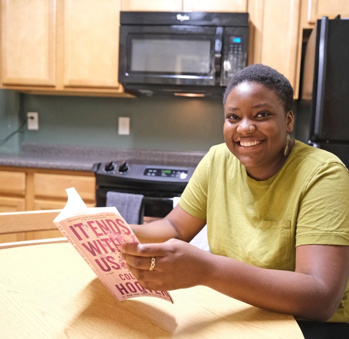 Female student in Simonds Hall reading in kitchen