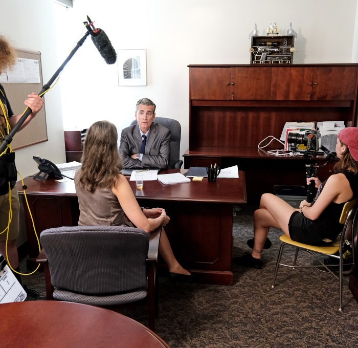 Students and actors filming in office