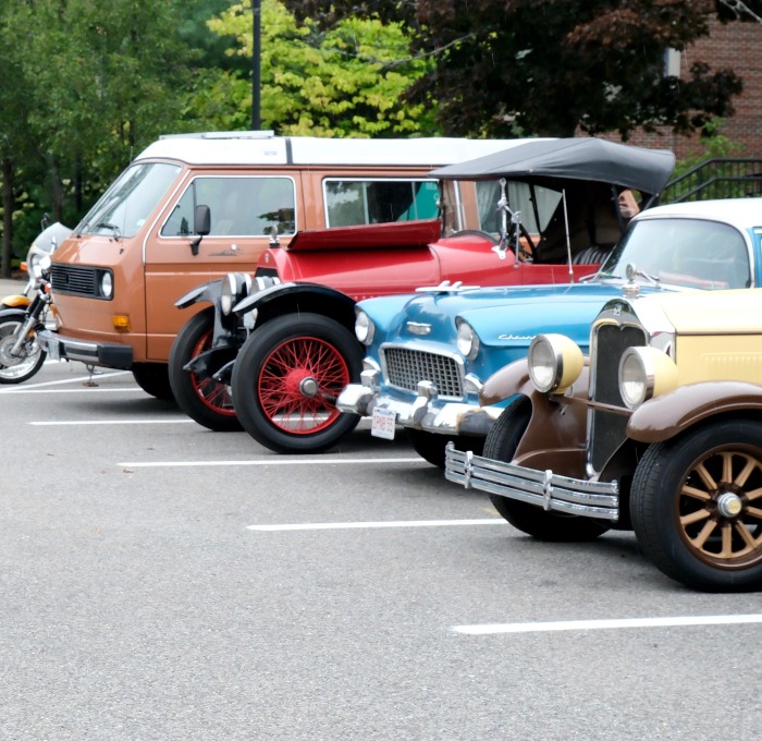 Alumni taking photo of cars at the car show in front of Mazzaferro