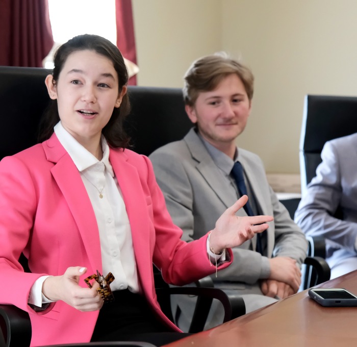 BSAD students discussing economy at conference table