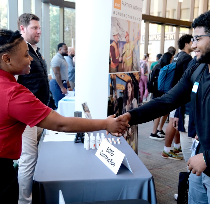Internship Fair student and employers shaking hands