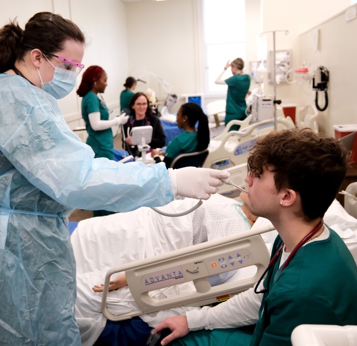 Nursing vitals lab students working on each other